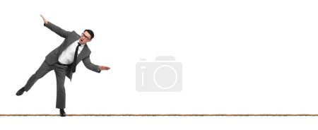 Photo for Risks and challenges of owning business. Man balancing on rope against white background, banner design - Royalty Free Image