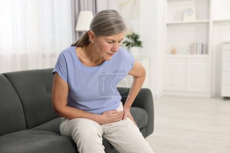 Photo for Arthritis symptoms. Woman suffering from hip joint pain at home - Royalty Free Image
