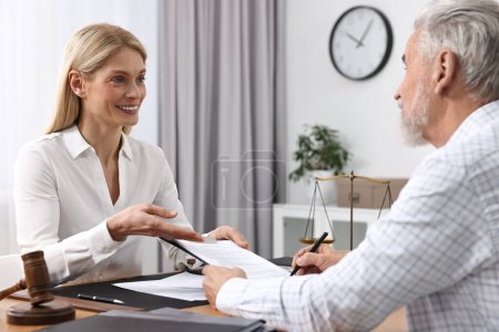 Photo for Senior man having meeting with lawyer in office - Royalty Free Image