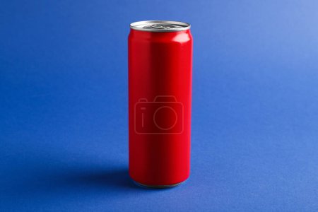 Bebida energética en lata roja sobre fondo azul