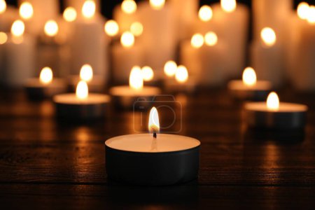 Brennende Kerzen auf dunkler Oberfläche. Gedenktag