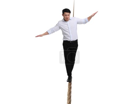 Photo for Risks and challenges of owning business. Man balancing on rope against white background - Royalty Free Image