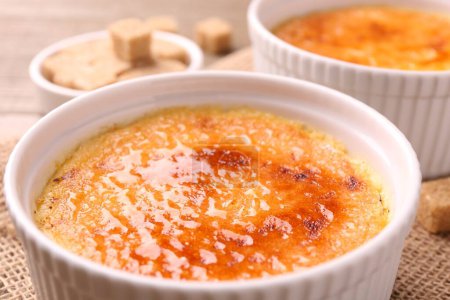 Photo for Delicious creme brulee in bowls on table, closeup - Royalty Free Image