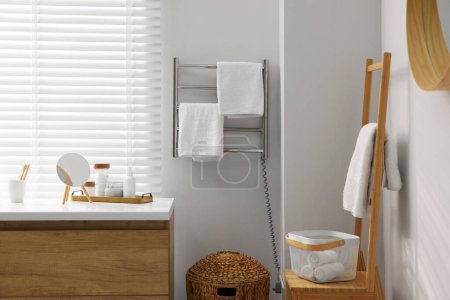 Photo for Stylish bathroom interior with heated towel rail and vanity - Royalty Free Image