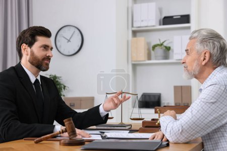 Photo for Senior man having meeting with lawyer in office - Royalty Free Image