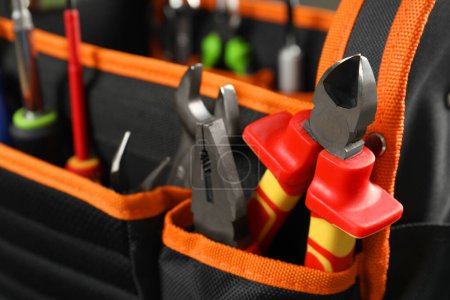 Photo for Bag with different pliers and other repair tools, closeup. Space for text - Royalty Free Image