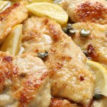 Delicious chicken piccata with lemons in pot, closeup