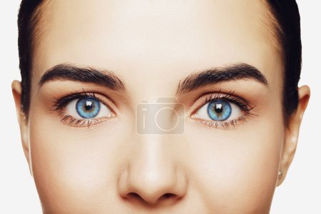Beautiful woman with captivating light blue eyes, closeup