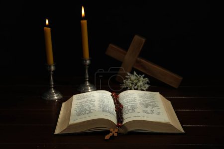 Photo for Crosses, rosary beads, Bible and church candles on wooden table - Royalty Free Image