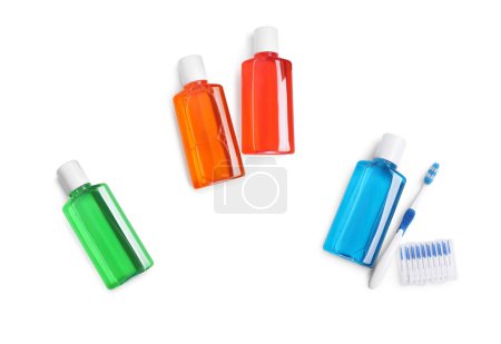 Fresh mouthwashes in bottles isolated on white, top view