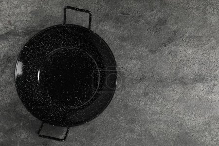 Photo for Empty iron wok on grey table, top view. Space for text - Royalty Free Image