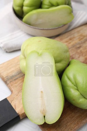 Photo for Cut and whole chayote on light table, closeup - Royalty Free Image
