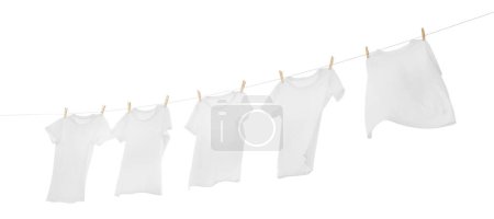 Photo for Many t-shirts drying on washing line isolated on white - Royalty Free Image