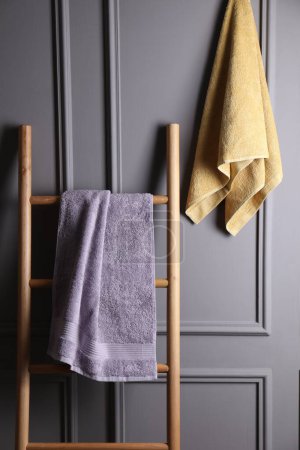 Soft terry towels and wooden ladder indoors