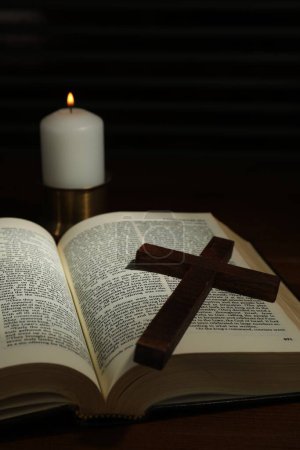 Photo for Cross, Bible and church candle on wooden table - Royalty Free Image
