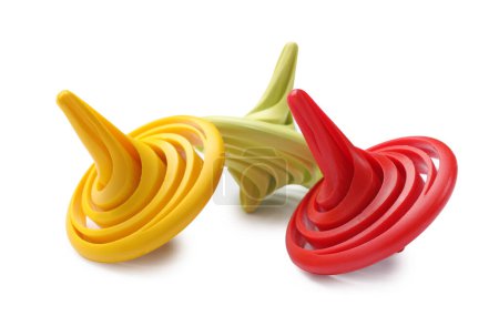 Three colorful spinning tops on white background