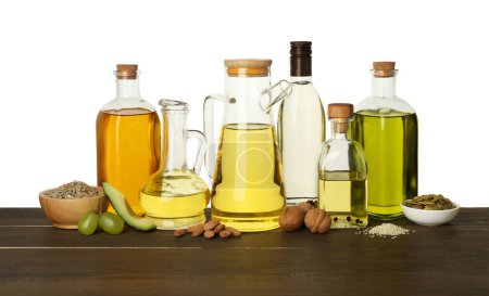 Photo for Vegetable fats. Different cooking oils and ingredients on wooden table against white background - Royalty Free Image