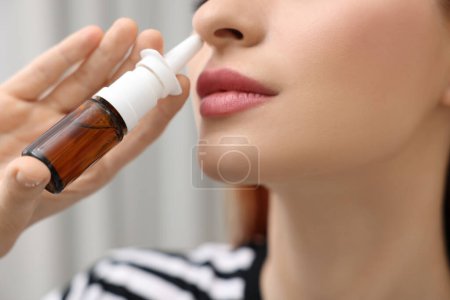Photo for Medical drops. Woman using nasal spray at home, closeup - Royalty Free Image