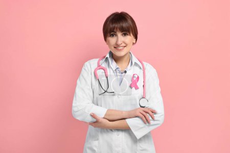 Mammologist with pink ribbon on color background. Breast cancer awareness