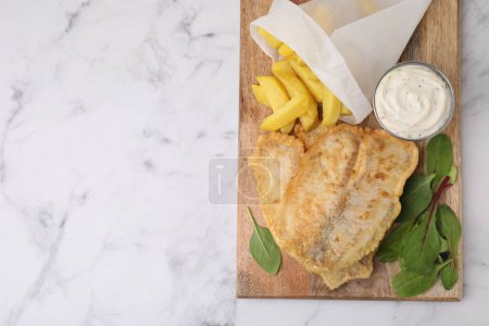 Délicieux fish and chips avec sauce savoureuse et mangue sur table en marbre blanc, vue sur le dessus. Espace pour le texte