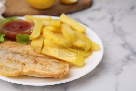Photo for Delicious fish and chips with ketchup and lettuce on light table, closeup - Royalty Free Image