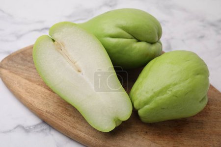 Photo for Fresh green chayote on light marble table, closeup - Royalty Free Image