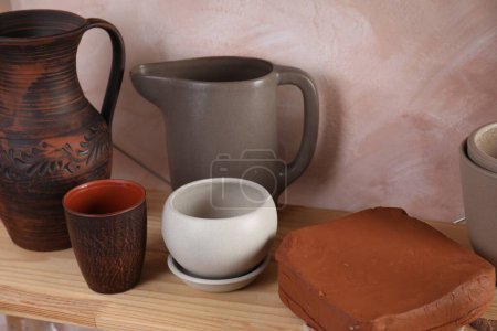 Clay dishes on wooden table in workshop