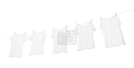 Photo for Many t-shirts drying on washing line isolated on white, low angle view - Royalty Free Image