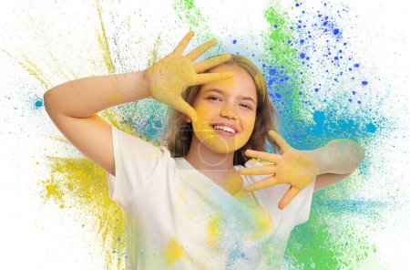 Fête du festival Holi. Joyeux adolescent fille couverte de colorants en poudre colorés sur fond blanc