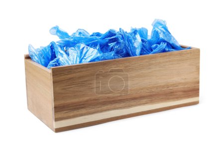 Blue medical shoe covers in wooden crate isolated on white