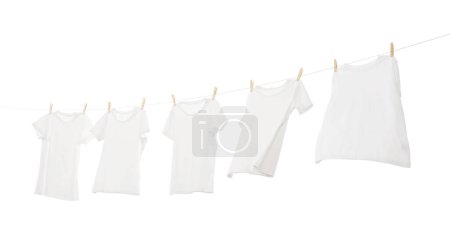 Photo for Many t-shirts drying on washing line isolated on white - Royalty Free Image