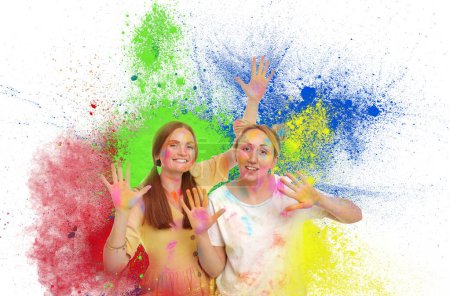Holi festival celebration. Happy women covered with colorful powder dyes on white background