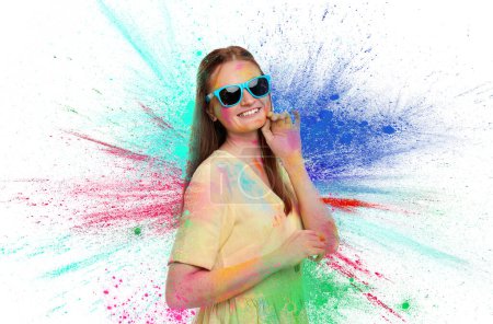 Holi festival celebration. Happy woman covered with colorful powder dyes on white background