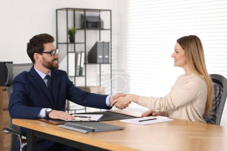 Photo for Lawyer shaking hands with client in office - Royalty Free Image