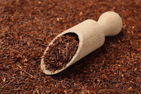 Rooibos tea and wooden scoop, closeup view