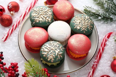 Foto de Bellamente decorado macarons de Navidad, bastones de caramelo y decoración festiva en la nieve, vista superior - Imagen libre de derechos