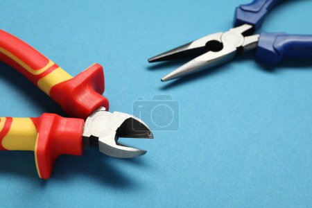 Photo for Pliers on light blue background, closeup view - Royalty Free Image