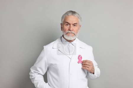 Mammologist with pink ribbon on gray background. Breast cancer awareness