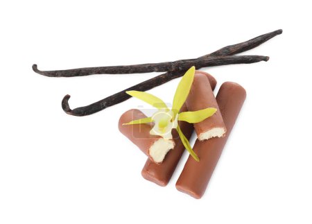 Glazed curd cheese bars, vanilla pods and flower isolated on white, top view