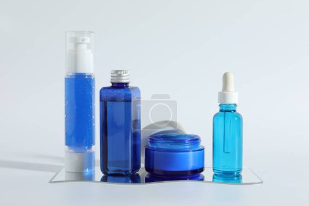 Photo for Different containers with cosmetic products on light background - Royalty Free Image