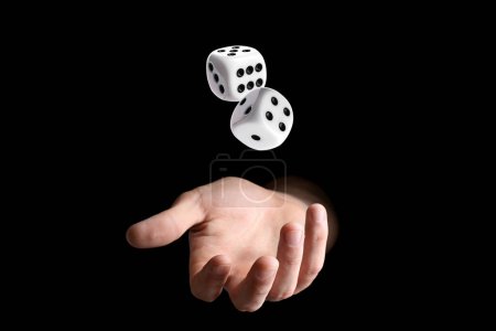 Man throwing white dice on black background, closeup