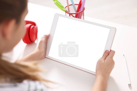Photo for E-learning. Girl using tablet for studying online at table indoors, closeup - Royalty Free Image