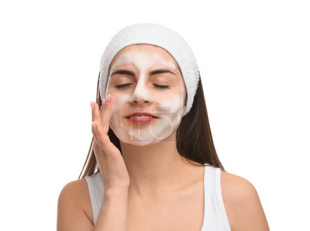 Photo for Young woman with headband washing her face on white background - Royalty Free Image