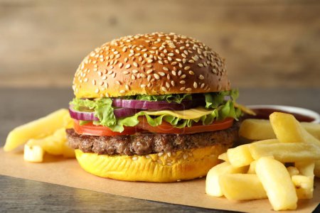 Photo for Burger with delicious patty and french fries on table, closeup - Royalty Free Image