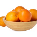 Fresh oranges in bowl isolated on white