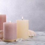 Spa composition with burning candles, flowers and sea salt on white marble table, space for text