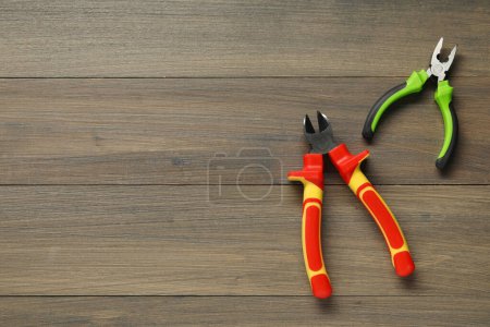 Photo for Pliers on wooden table, flat lay. Space for text - Royalty Free Image