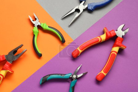 Photo for Different pliers on color background, flat lay - Royalty Free Image