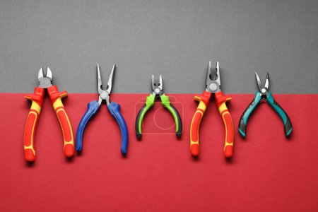 Photo for Different pliers on color background, flat lay - Royalty Free Image