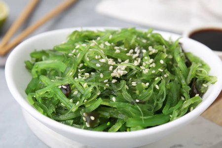 Tasty seaweed salad in bowl on table, closeup